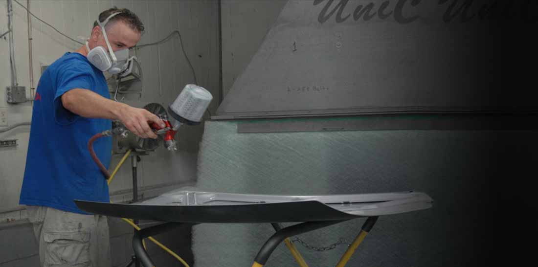 Certified technicians at Definis State Auto Body performing precision repair work