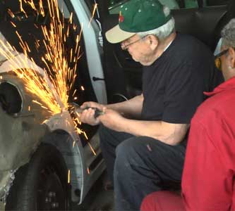 Gus Definis, founder of Definis State Auto Body, in the early years of the shop
