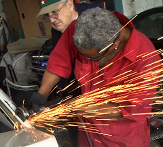 Expert welding work with sparks at Definis State Auto Body
